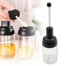 Durable glass seasoning jar with spoon for spices.
